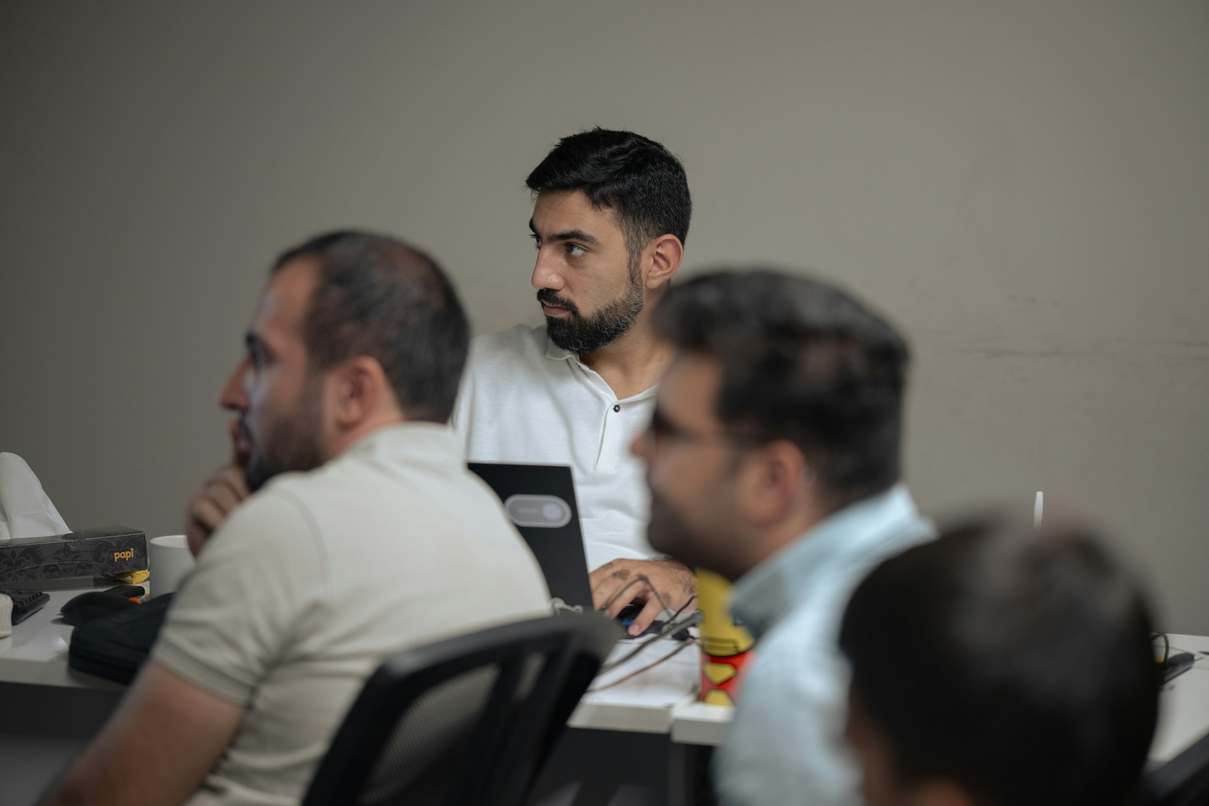 Trainees seated at desks following a session in a training room