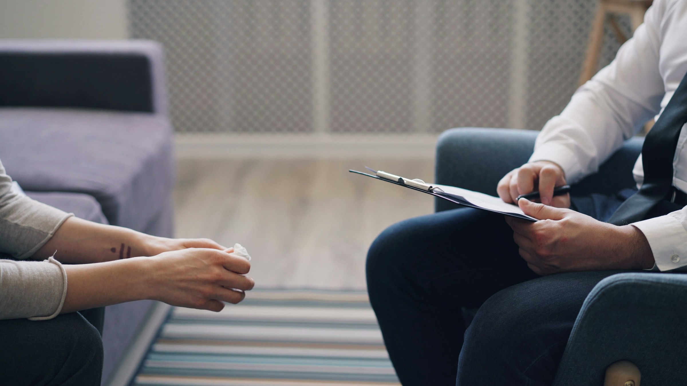 Counsellor with a clipboard in conversation with a candidate